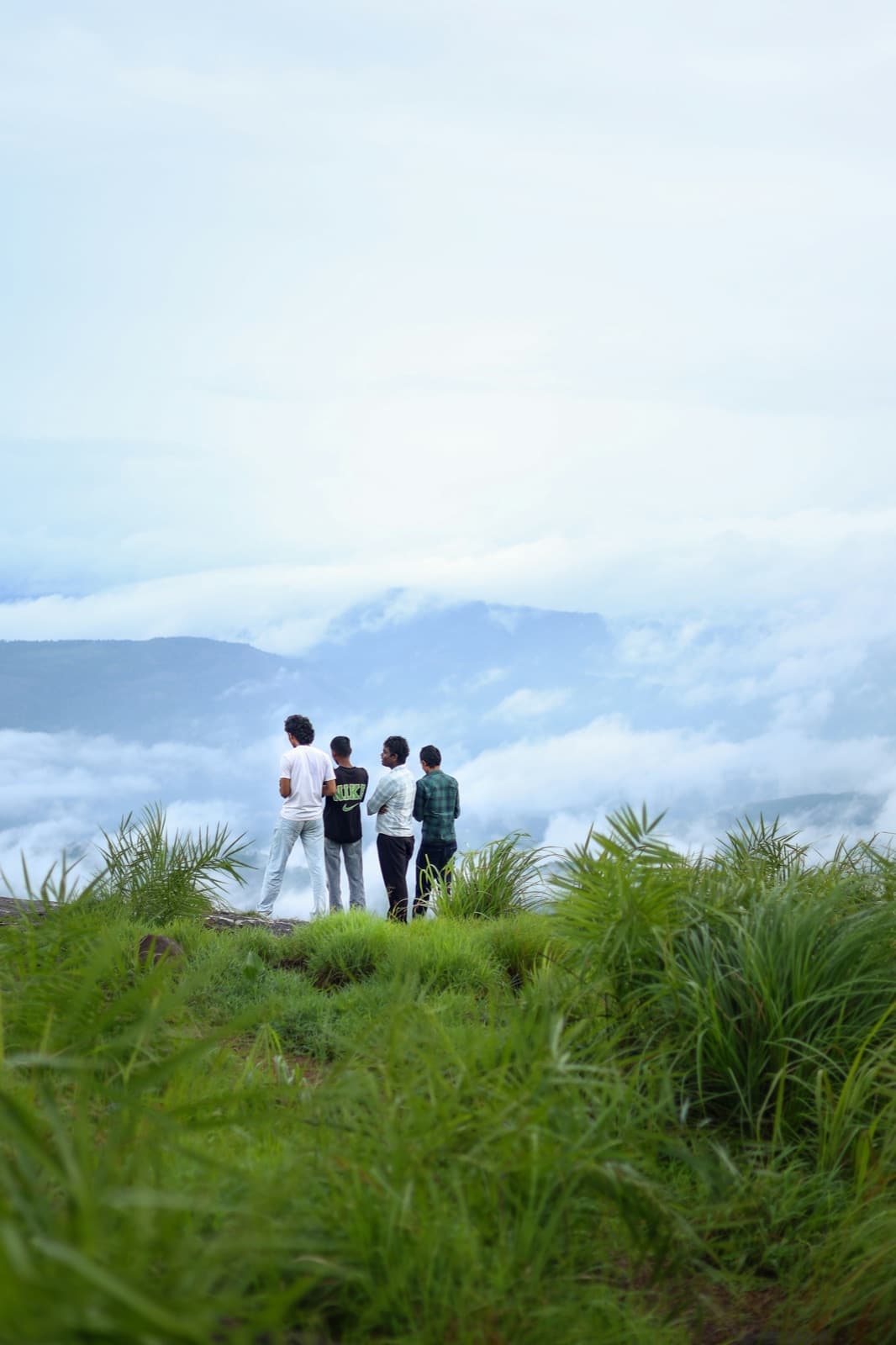 Friends enjoying a misty mountain viewpoint